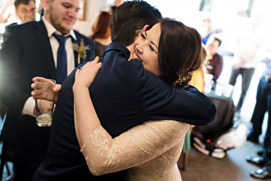 A bride hugs the best man after a great speech.